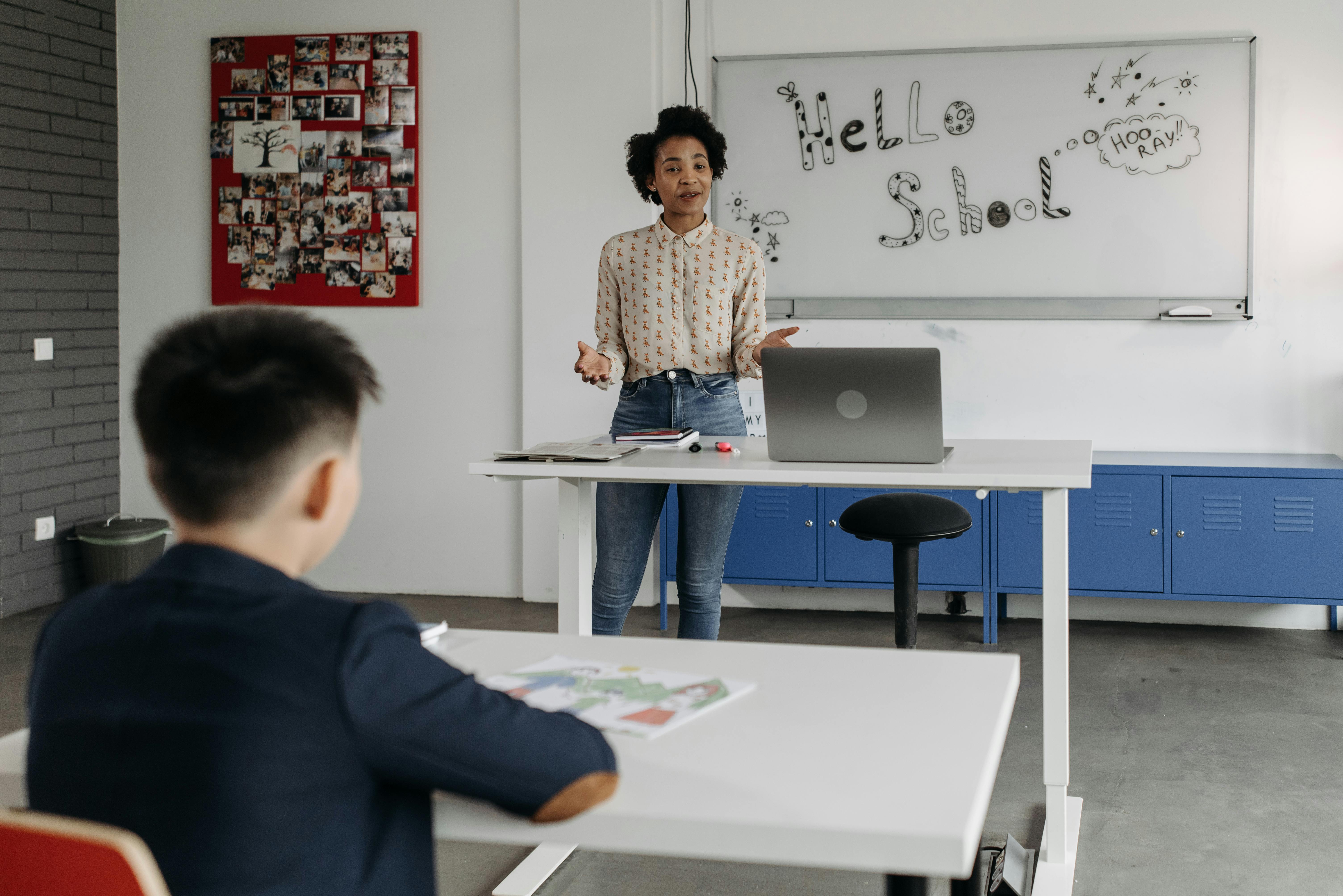 Educator leads interactive lesson in a classroom with a whiteboard display.